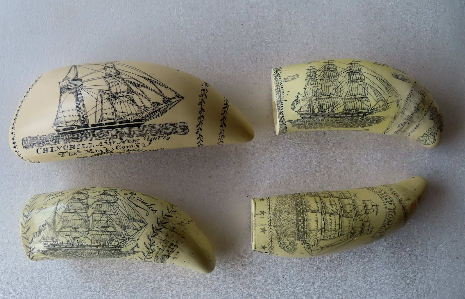 Grouping of 4 reproduction resin scrimshaw whale teeth, one signed J.A. depicting sailing ship and: Grouping of 4 reproduction resin scrimshaw whale teeth, one signed J.A. depicting sailing ship and Lady Liberty waving American flag, another with 2 American whalers signed PMS Artek, and 2 others not