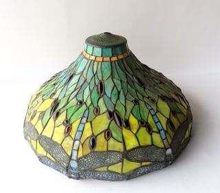 A slag glass lamp shade, dragon fly design, unknown maker and age. Very good condition. Measures 20