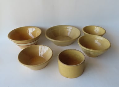 Five yellowware bowls including 3 banded mixing bowls, 1 plain yellowware mixing bowl, and a milk