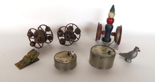 Grouping of vintage toys including: A lithograph tin cricket clicker; a metal bird form whistle; 2
