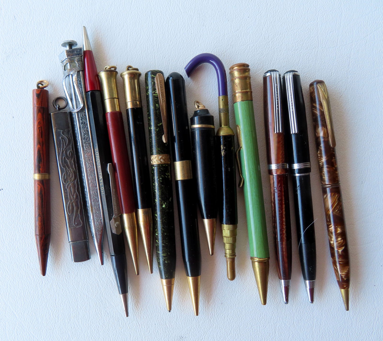 Grouping of 12 vintage lead pens by various makers, an unusual umbrella shaped extendable pencil: Grouping of 12 vintage lead pens by various makers, an unusual umbrella shaped extendable pencil holder, and a sterling silver lead pen refill holder. Most in good condition. The pencil holder with ma