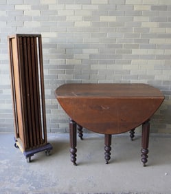 A black walnut drop-leaf banquet table with 5 leaves and center support leg, very good original