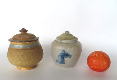 Two lidded sugar or spice bowls, 19th century. The first in stoneware, decorated with an embossed