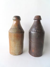 Two stoneware beer bottles. The first signed J. P. Plummer 1852 - 9 3/4"H - some staining, else very