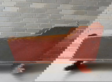 A primitive wooden cradle in original red paint. Some use wear, but overall good condition, early to