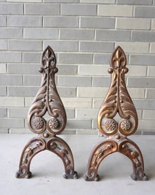A pair of cast iron Arts & Crafts andirons with original bronze finish, decorated with acanthus