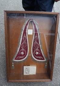 A framed Masonic lodge collar with "The Odd Fellow's Pocket Companion" dated 1877 - housed in a
