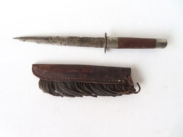 A frontier double edge Bowie knife with a hand made leather sheath with fringe, 19th century. Some