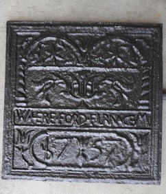 A newer cast iron fireback, museum copy, signed "W. HEREFORD FURNACE M." decorated with tulips -