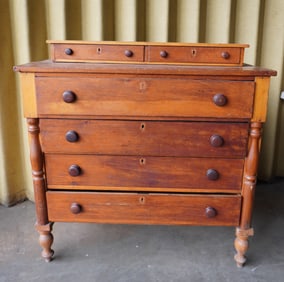 A late Sheraton poplar wood chest of drawers with step-back top with 2 glove drawers, over 4 drawers