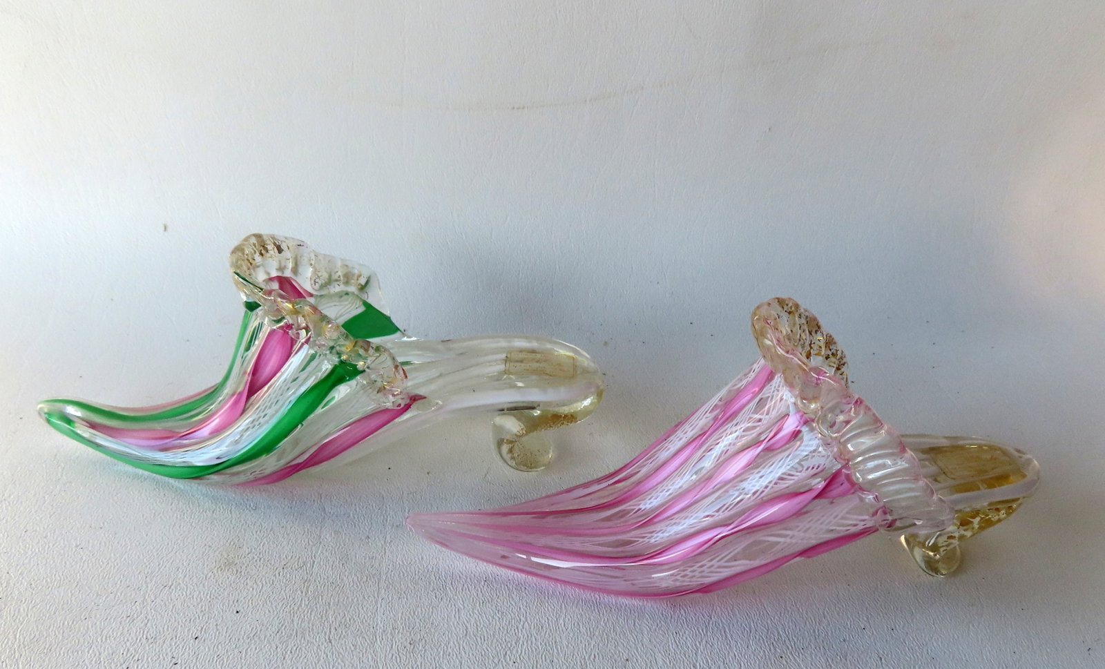 A beautiful pair of Murano glass slippers with pink, green and colorless twisted bands and gold: A beautiful pair of Murano glass slippers with pink, green and colorless twisted bands and gold speckles, with original label marked "Vetreria Artigianale / D' Este / Made in Italy / Murano (VE)", cir