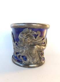 An unusual porcelain Art Nouveau mug hand painted in cobalt blue with applied silver plate rim and