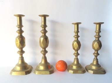 Two pair of English brass pushup candlesticks in the diamond pattern. The larger pair, 14"H, marked
