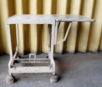 An industrial sheet metal typewriting table with single drop-leaf, early to mid 20th century, in old