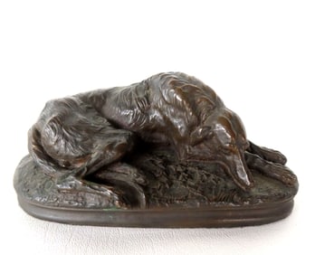 A small bronze of sleeping dog,  appears to be signed M. Deva, probably mid 20th century. Measures 6