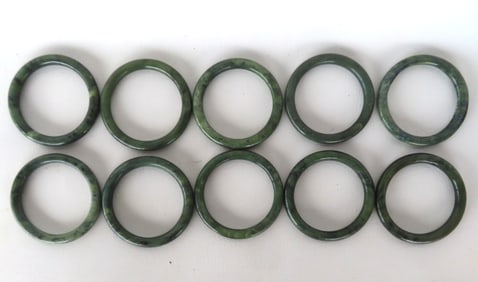 Grouping of 10 jadeite or jade bangle bracelets, all in good condition. The opening measures 2 1/4"