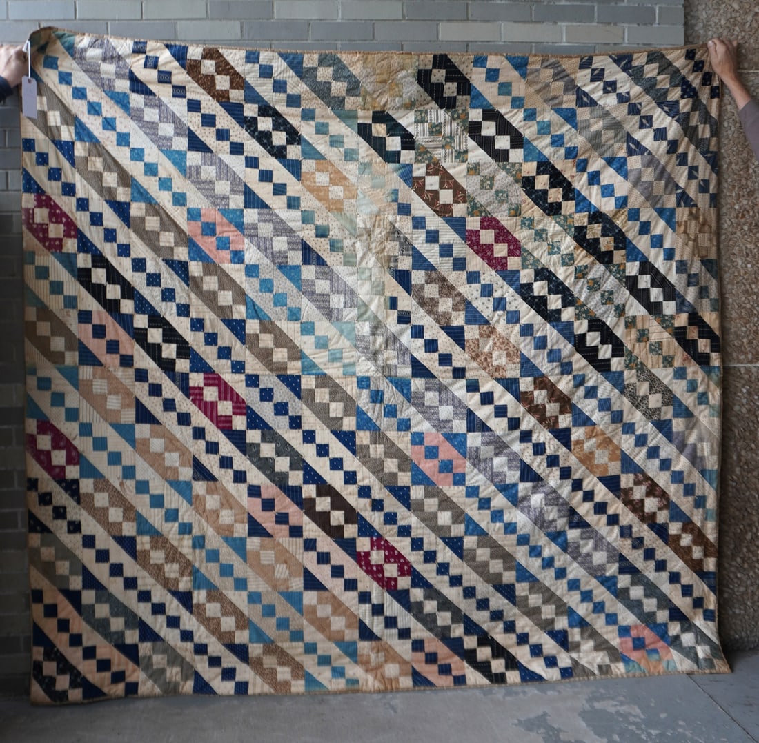 A patchwork quilt hand sewn, early to mid 20th century. Small area with faded fabric, stain on borde (1 of 7)