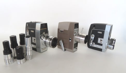 Three vintage Bell & Howell Super 8 movie cameras, one with 3 lens mount, and the other 2 with telep