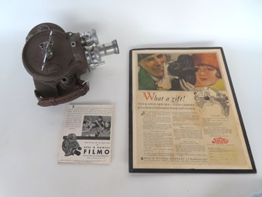 A Bell & Howell Filmo 16 MM movie camera with 3 lenses. Windup motor does not appear to be working b