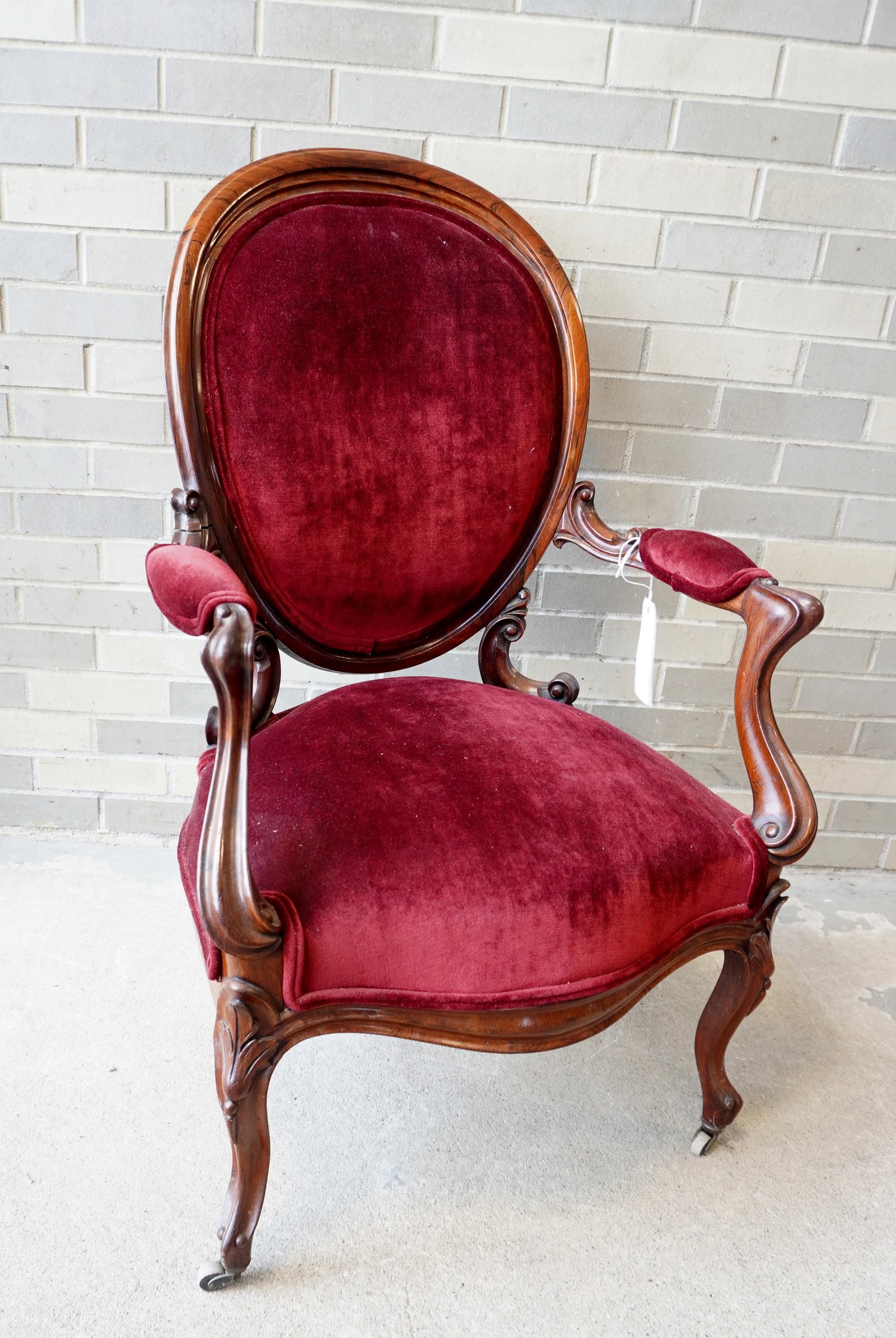 A very fine rosewood lady's parlor chair circa 1870-80.: A very fine rosewood lady's parlor chair with newer upholstery. One of the fancy arm supports that attached to the back frame and one of the lower back supports with breaks and needs to be glued (very