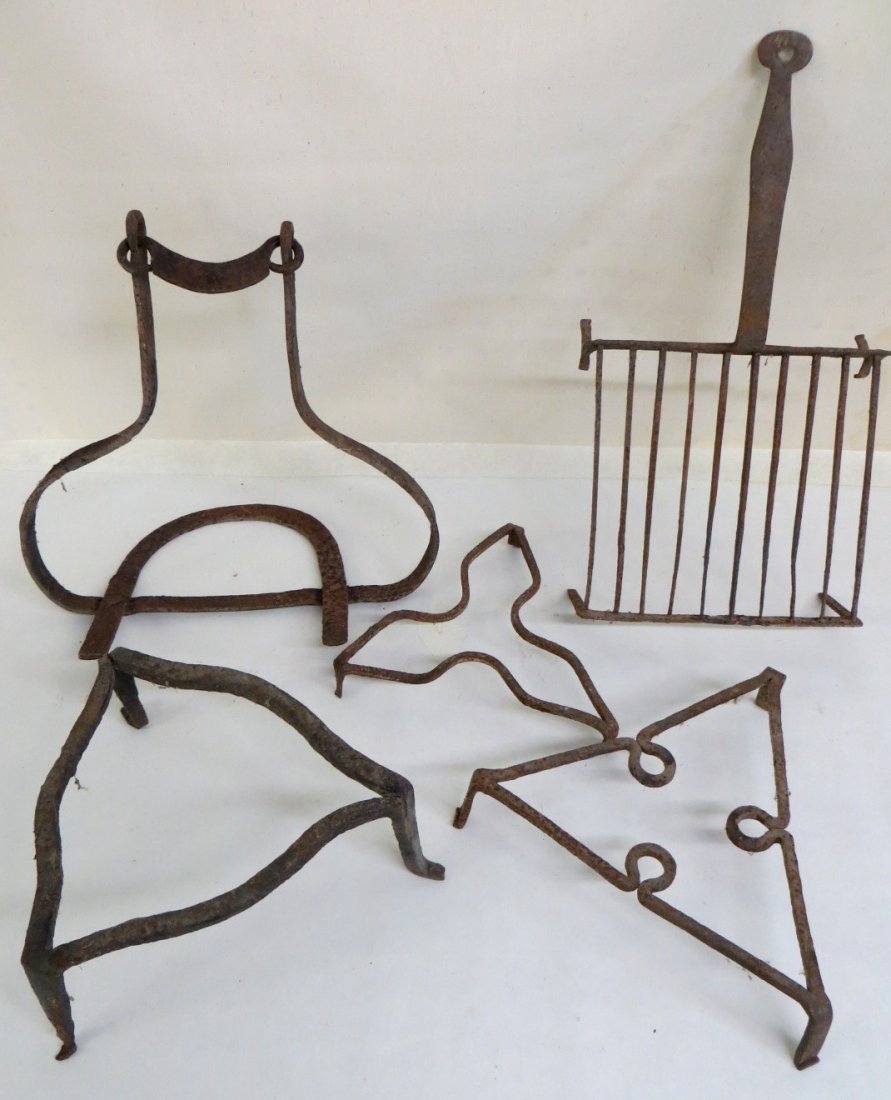 Four footed hand forged iron trivets plus 1 iron hangin: Four footed hand forged iron trivets plus 1 iron hanging pot holder. Early 19th century.