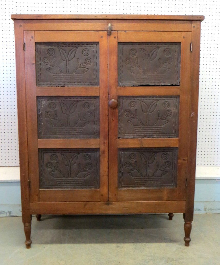 Pierced Tin Piece Safe With 12 Basket Of Flower Tins: Pierced tin pie safe with 12 basket of flower tin panels - 3 panels on each side and 3 panels on each door - some tin panels with breaks/rust on perimeter - 19th century. 52"H x 40.5"W x 17.25"D.