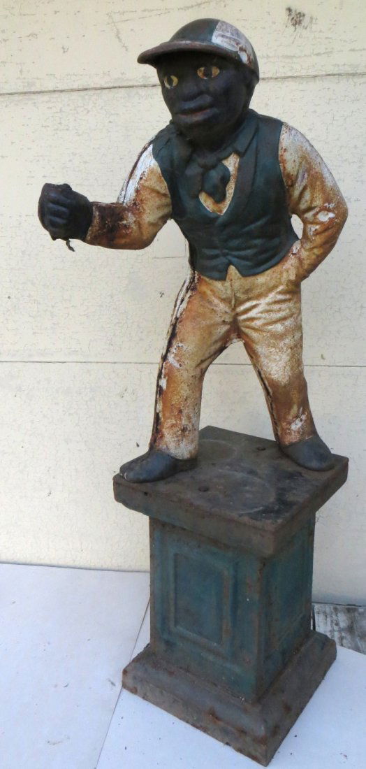 Cast iron lawn jockey on iron plinth. Original paint