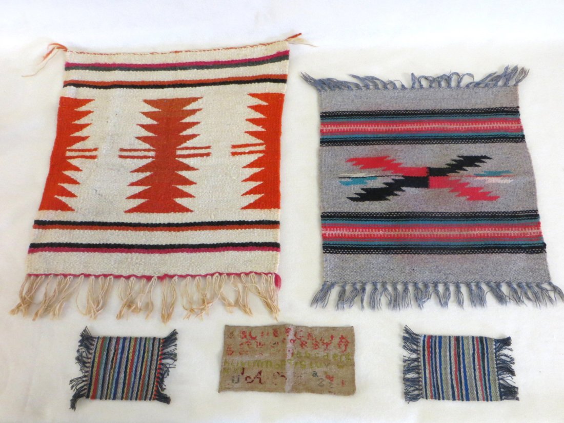 Five miniature textiles including 2 Native American rug: Five miniature textiles including 2 Native American rugs, 2 doll house rag rugs, worn miniature sampler.