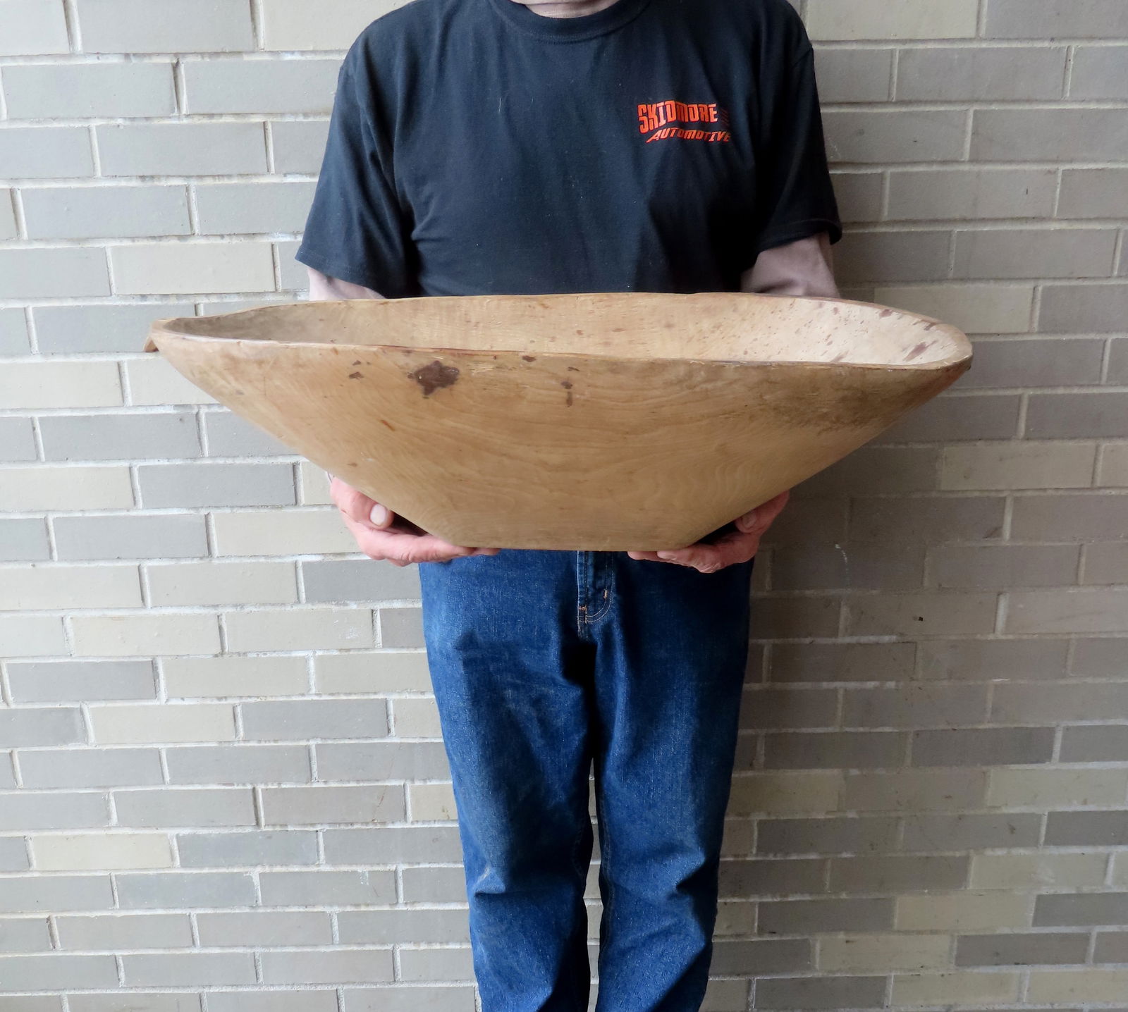 An large early oval dugout bowl with handles on each end carved from the same section of wood, (1 of 14)