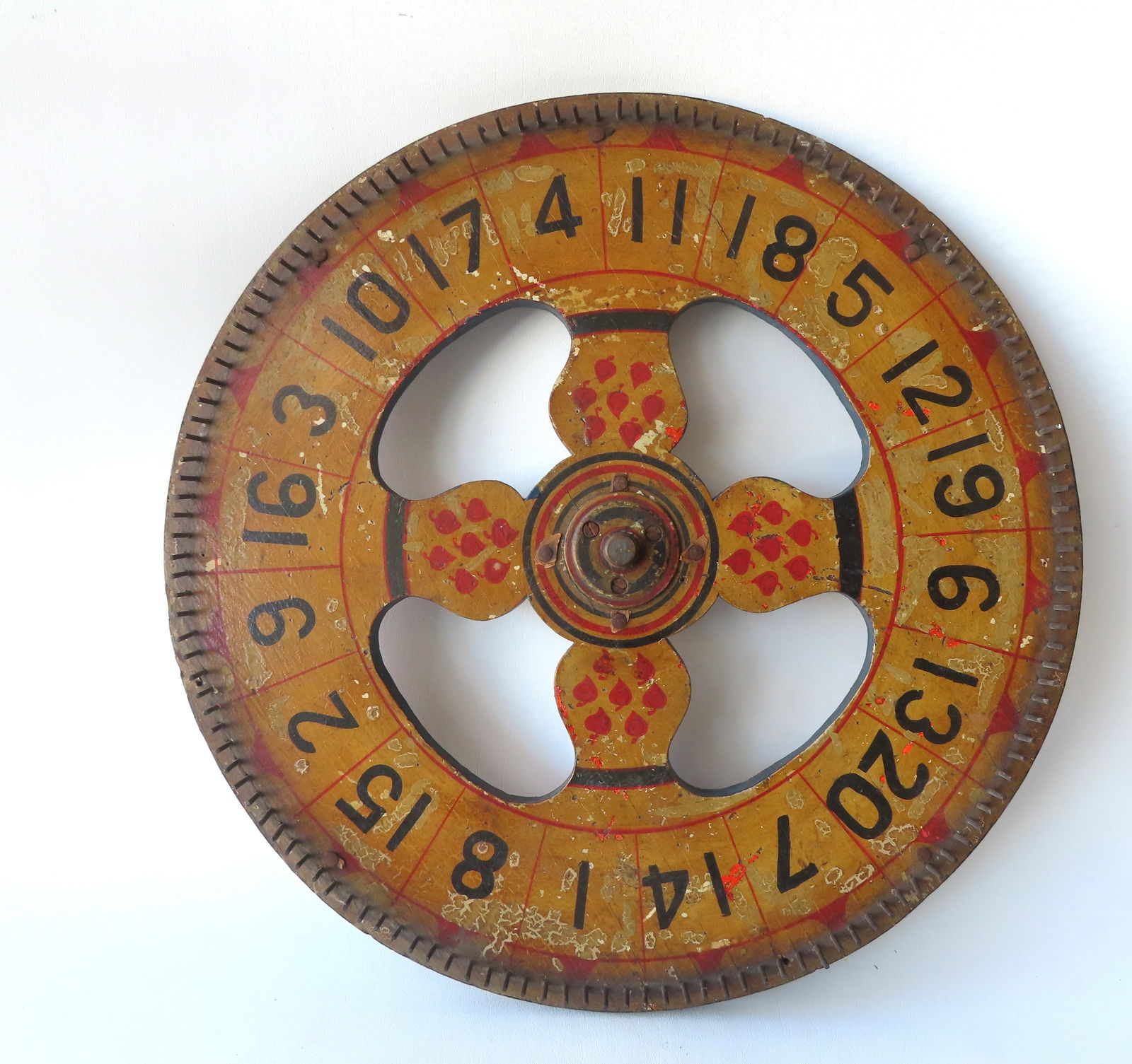 A colorful gaming wheel in original paint, having black numbers on mustard colored ground and also (1 of 6)