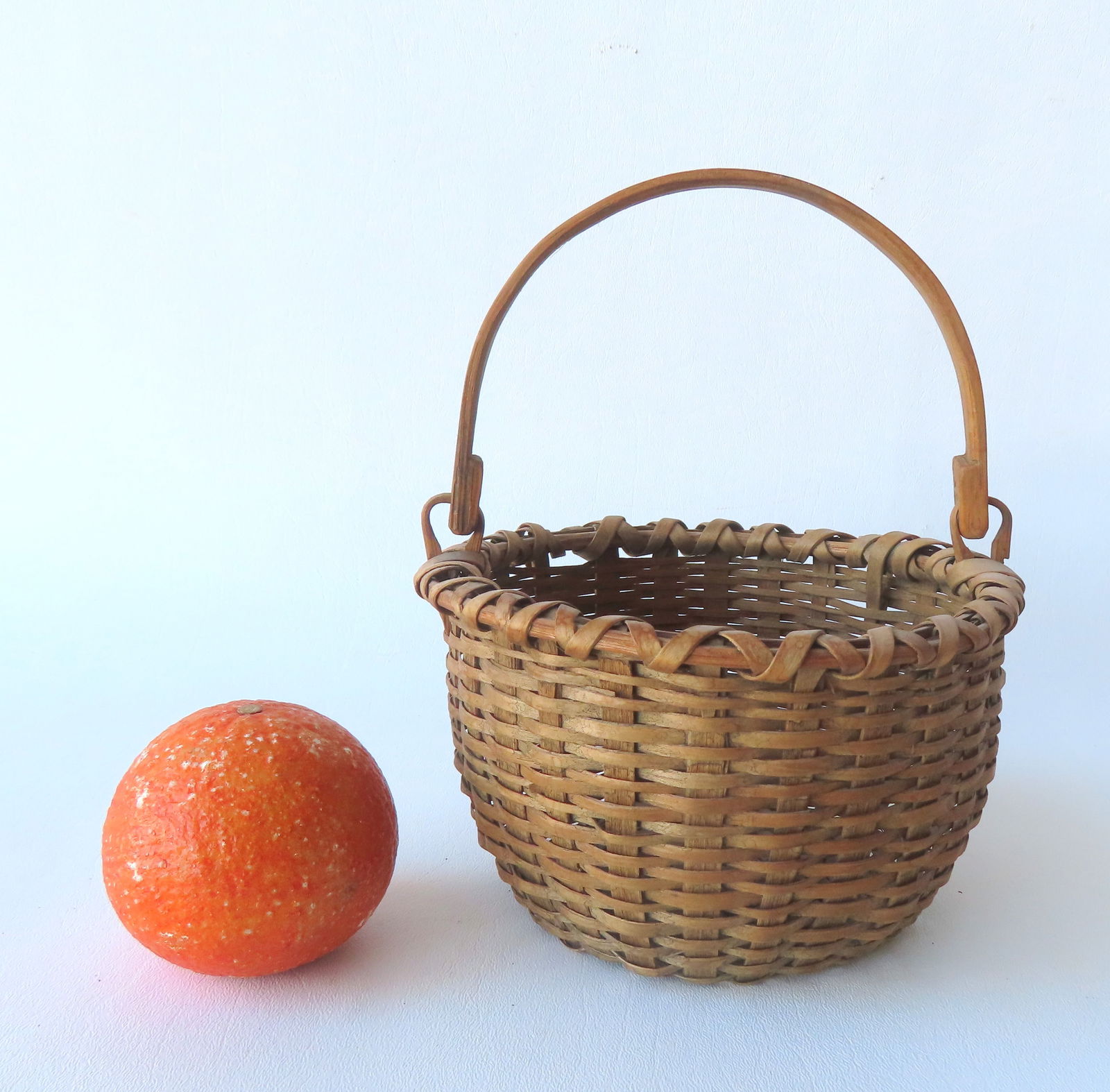 A very small Taghkanic swing handle basket, excellent condition, no breaks - late 19th century. Meas: A very small Taghkanic swing handle basket, excellent condition, no breaks - late 19th century. Measures 7" dia. X 5"H (to top of ears). 10 3/4"H.
