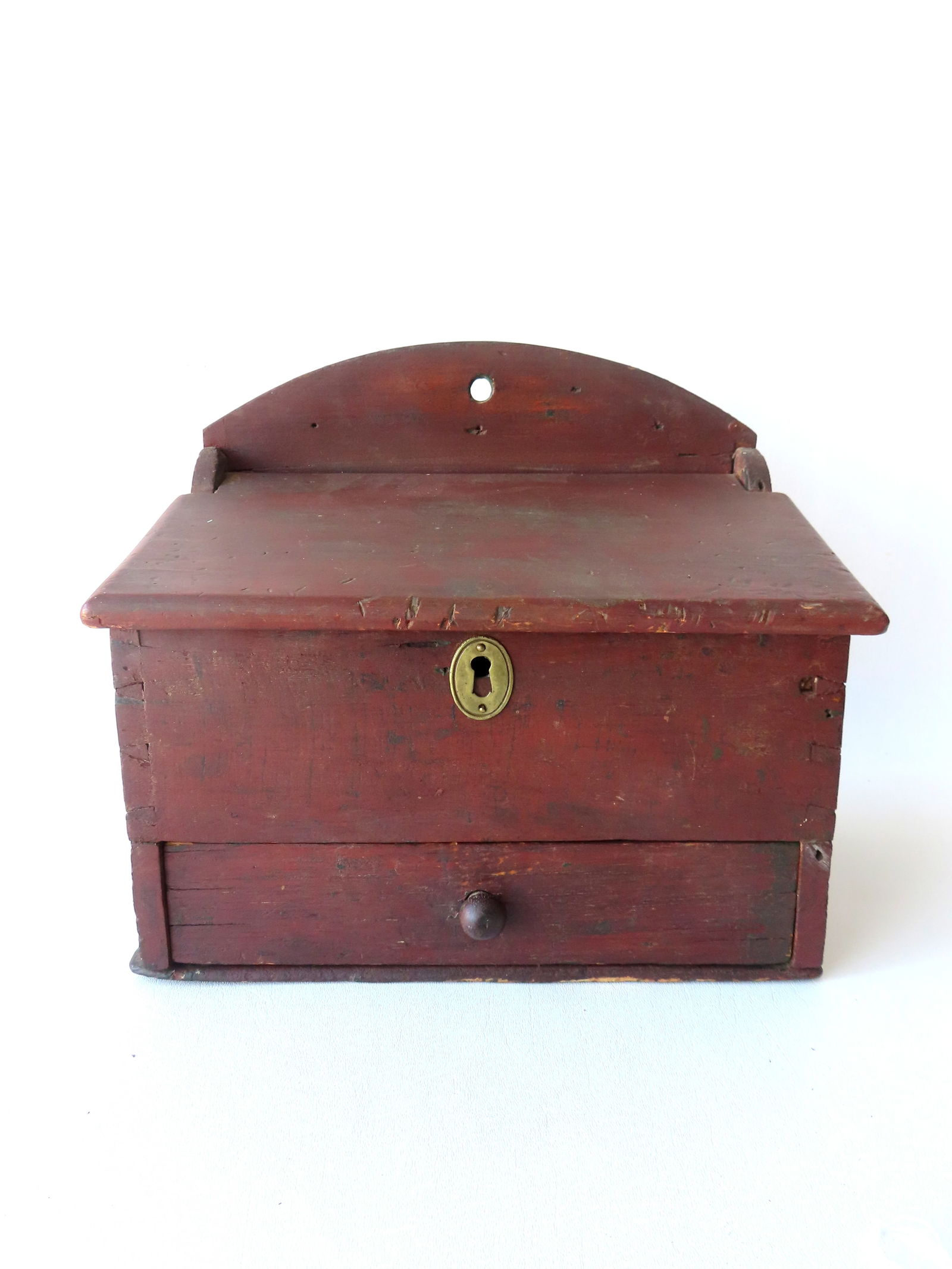 A primitive farmhouse wall box with slanted lid and lower drawer with fitted interior in original: A primitive farmhouse wall box with slanted lid and lower drawer with fitted interior in original red paint - dovetailed case - probably early 19th century. These boxes usually hung on a kitchen or fi
