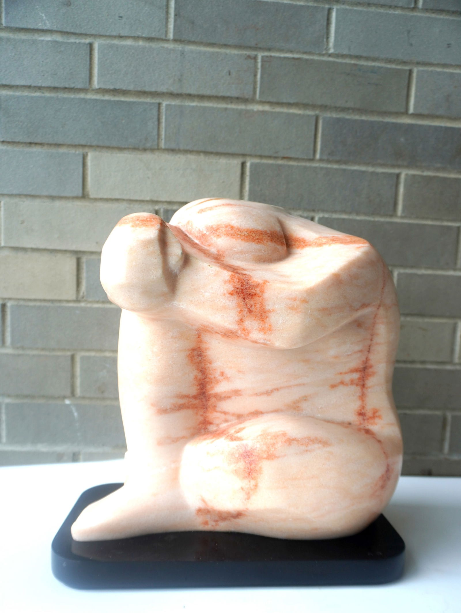 Lilly M. Tussey (Bulgarian/American d.2005). Modernistic marble sculpture of person in: Lilly M. Tussey (Bulgarian/American d.2005). Modernistic marble sculpture of person in contemplation. Titled on paper label attached to sculpture "Pink Dreams" and signed on base "Lilly Tussey" - Meas