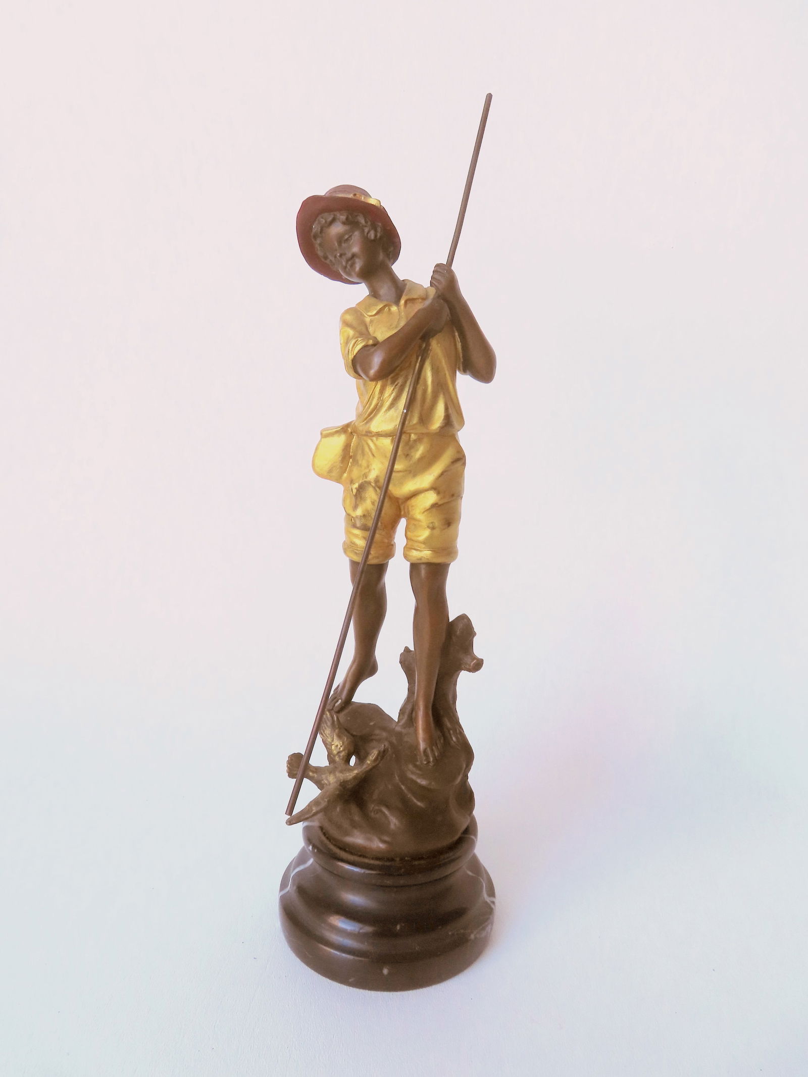 Miguel Fernando Lopez (Milo) - Portugal, born 1955. A bronze sculpture of boy fishing or spearing: Miguel Fernando Lopez (Milo) - Portugal, born 1955. A bronze sculpture of boy fishing or spearing with angry duck at his feet, in original gilding, signed Milo, 20th century. Mounted on a stepped marb