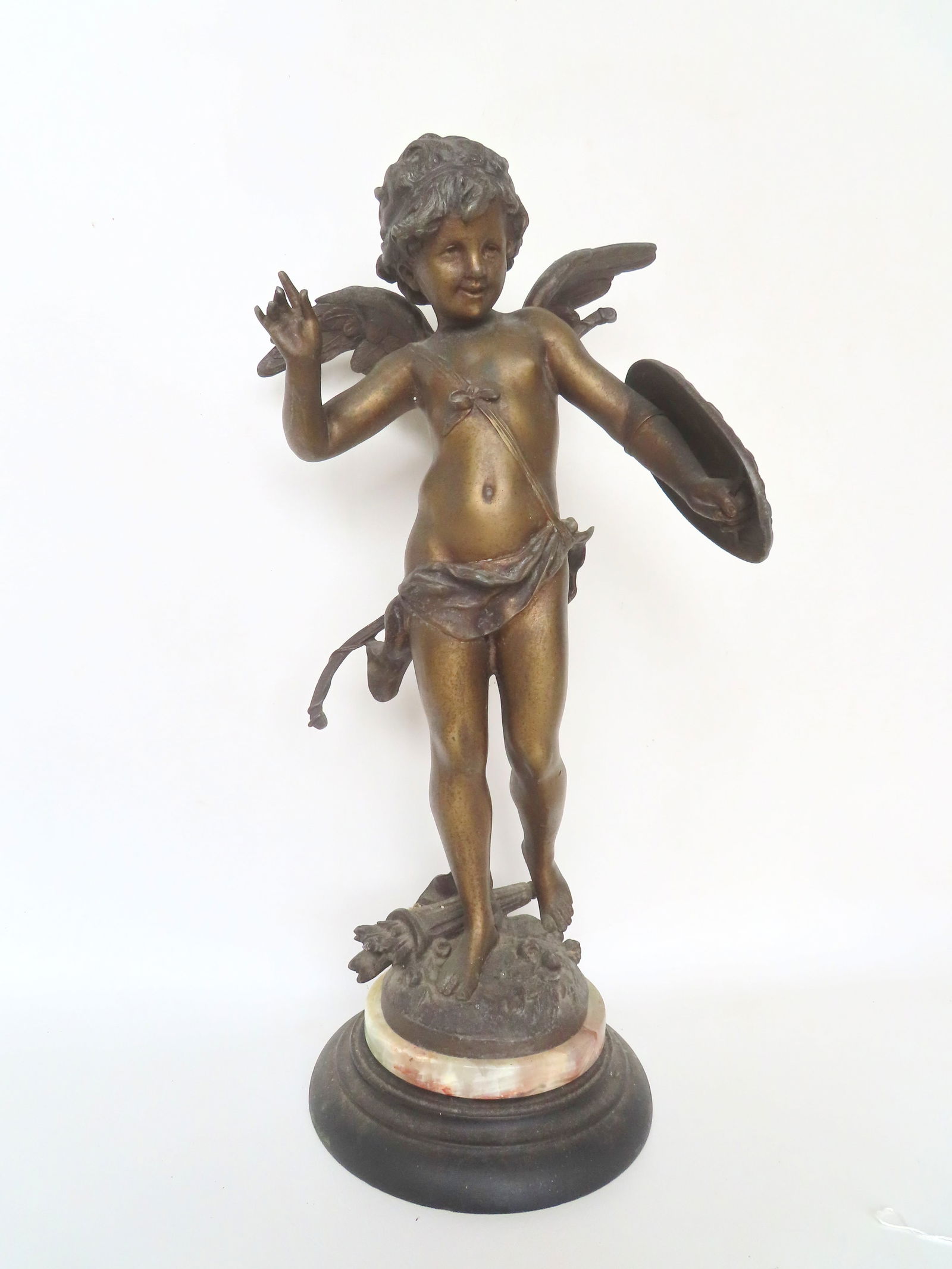 A Victorian spelter sculpture with a bronze finish, depicting a standing cupid holding a shield with: A Victorian spelter sculpture with a bronze finish, depicting a standing cupid holding a shield with embossed pierced arrow heart, a bow attached to his back, and arrows in quiver at his feet. Marked