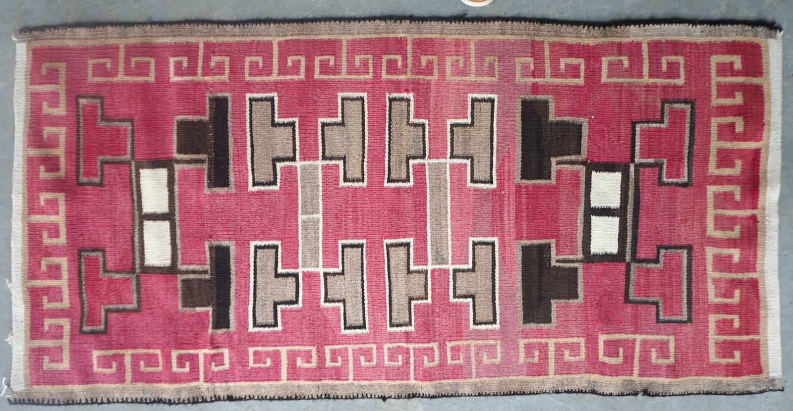 A Navajo scatter rug in red, brown and gray colors, geometric design, circa 1900, in very good: A Navajo scatter rug in red, brown and gray colors, geometric design, circa 1900, in very good condition - measures 67" x 33 1/2".