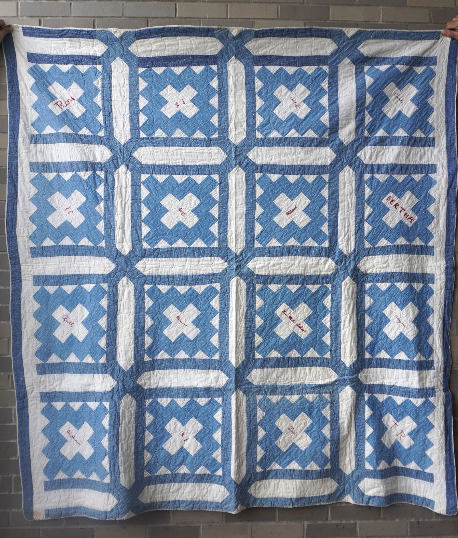 A blue and white hand sewn friendship quilt, crocheted into the center "Ten Mile School" and with (1 of 5)
