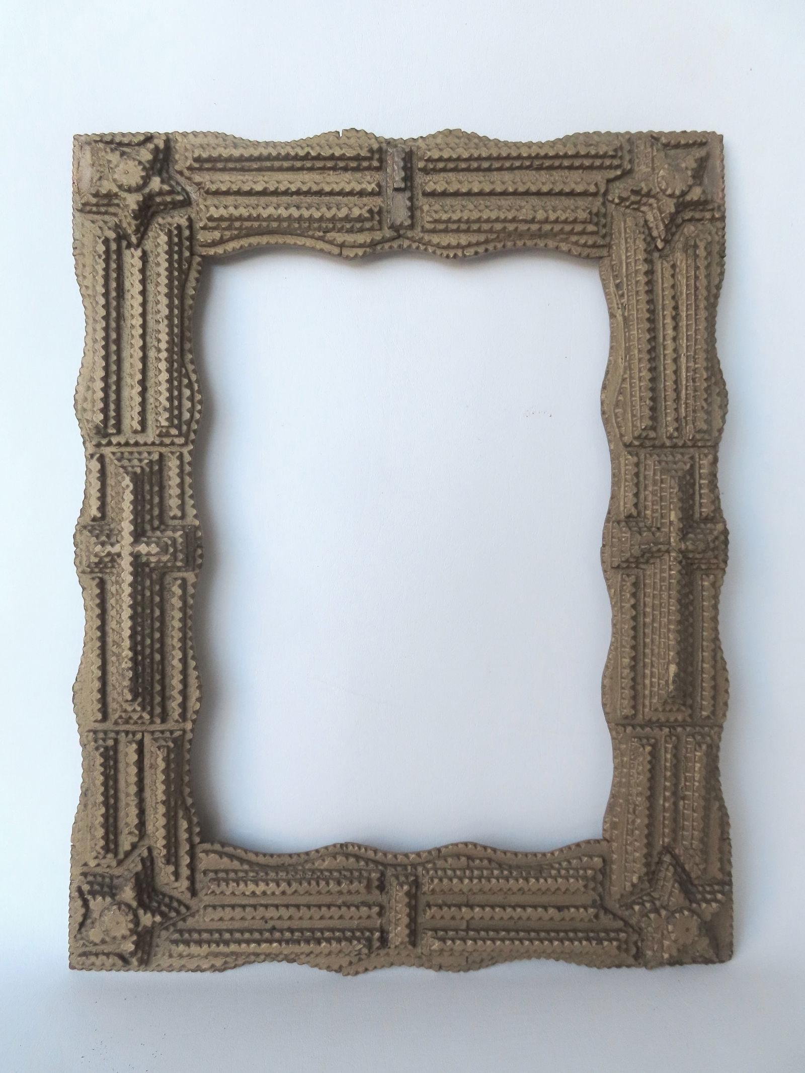 A tramp art frame with stars in corners, in original gold paint. Total frame size 20 1/4" x 16" and: A tramp art frame with stars in corners, in original gold paint. Total frame size 20 1/4" x 16" and opening 11 1/2" x 16". Good overall condition. Provenance: From the Marni Bakst and William Sadler c