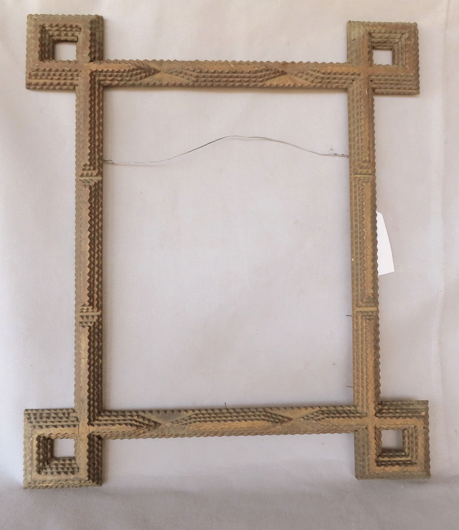 A large tramp art frame in original darkened gilt paint, 19th century, very good condition. Total: A large tramp art frame in original darkened gilt paint, 19th century, very good condition. Total frame size 28 1/4" x 33" - opening dimension 17 3/4" x 23".