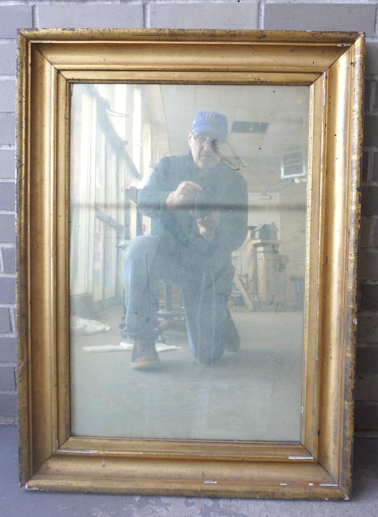 A 19th century mirror housed in its original lemon gold frame and having its original backboard, (1 of 4)