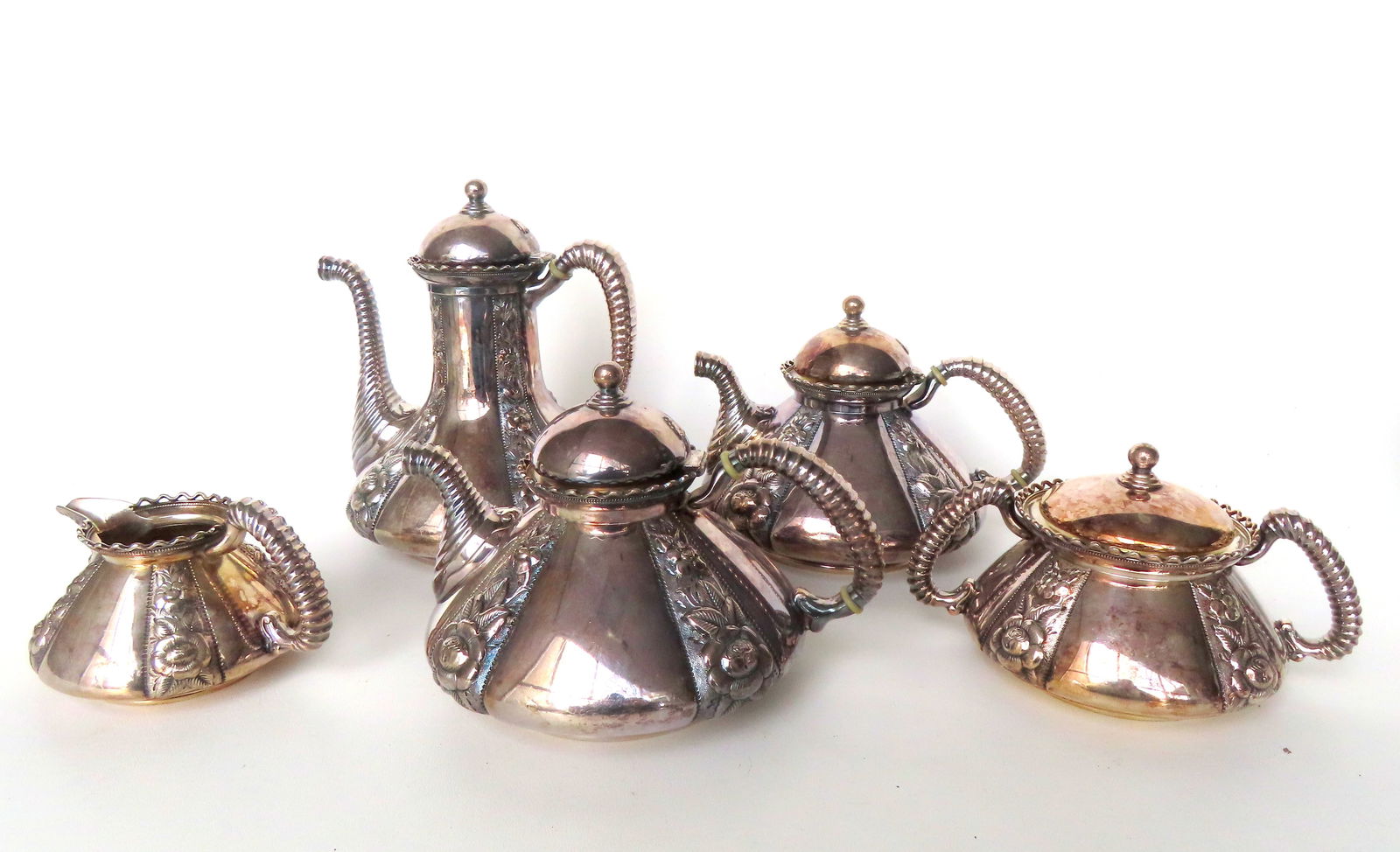 A fancy Wilcox silver-plate tea/coffee set consisting of coffee pot, 2 teapots, sugar bowl, and (1 of 7)
