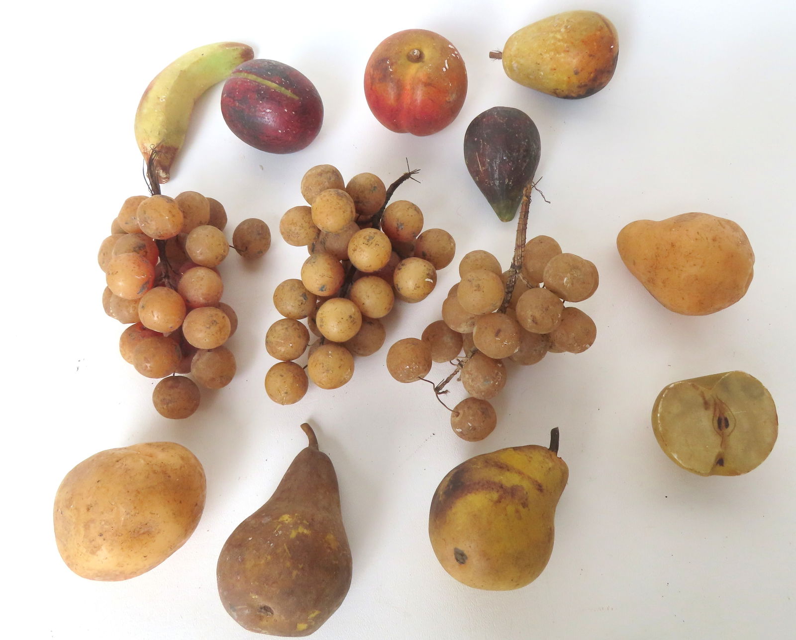 Grouping of vintage stone and wax fruit including: Six pieces of stone fruit including a rare hand: Grouping of vintage stone and wax fruit including: Six pieces of stone fruit including a rare hand painted 1/2 apple showing pits in original paint, early to mid 20th century; and 6 pieces of wax frui