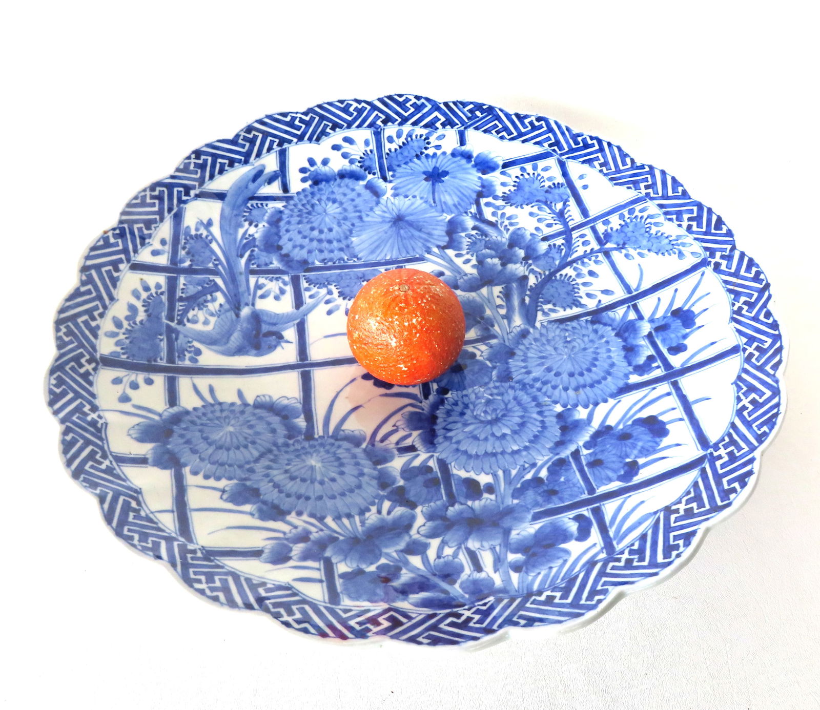 A Chinese export charger, hand painted in blue and white, and decorated with an exotic bird and a: A Chinese export charger, hand painted in blue and white, and decorated with an exotic bird and a flowering tree, probably early 20th century. Measures 18" diameter x 3" depth.