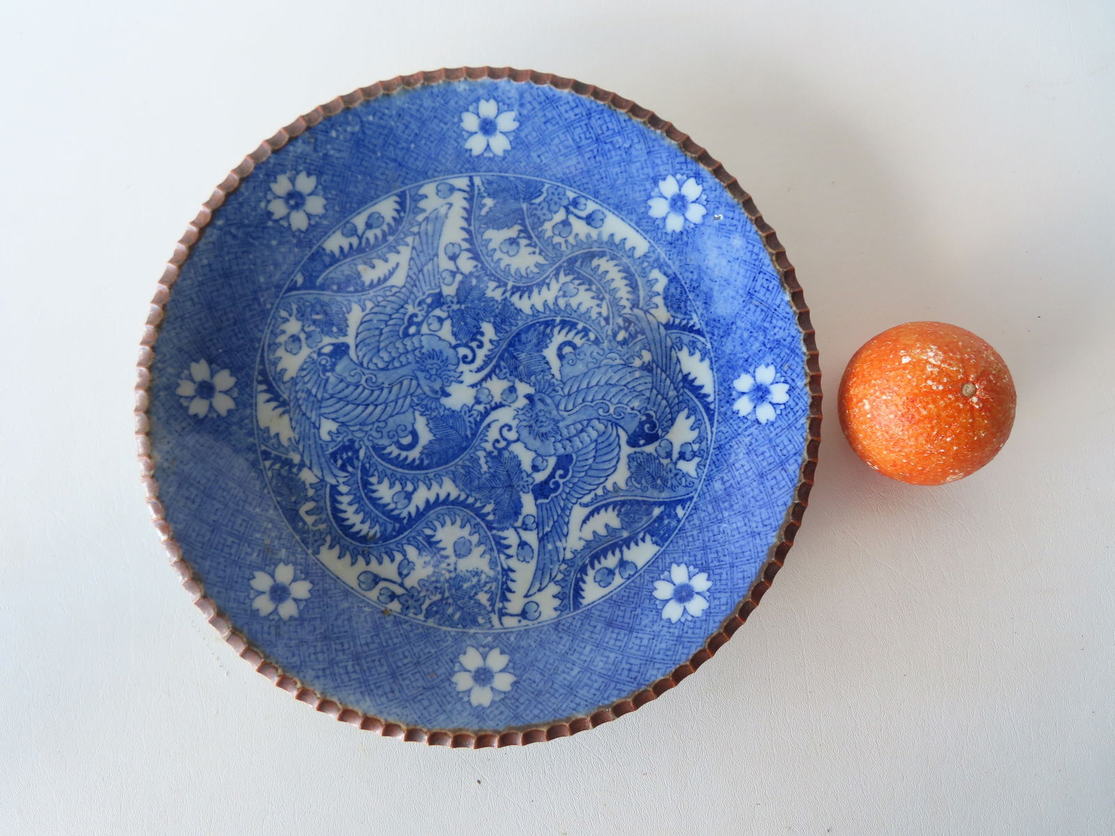 A Chinese export blue and white charger decorated with 2 long winged stylized birds, one appearing: A Chinese export blue and white charger decorated with 2 long winged stylized birds, one appearing to be an American Eagle, both surrounded by leaves and flowers and having a floral border around rim