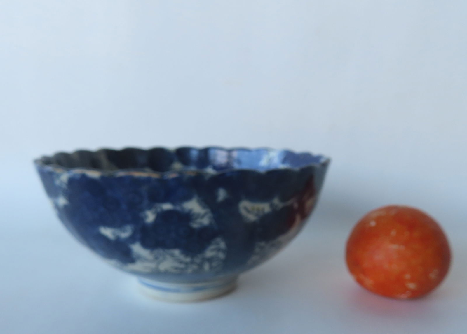 A Chinese export blue and white footed bowl, having a spider web design on interior base surrounded: A Chinese export blue and white footed bowl, having a spider web design on interior base surrounded by trees with flowers on the interior and exterior, 18th/19th century. Small glazing chip on outside