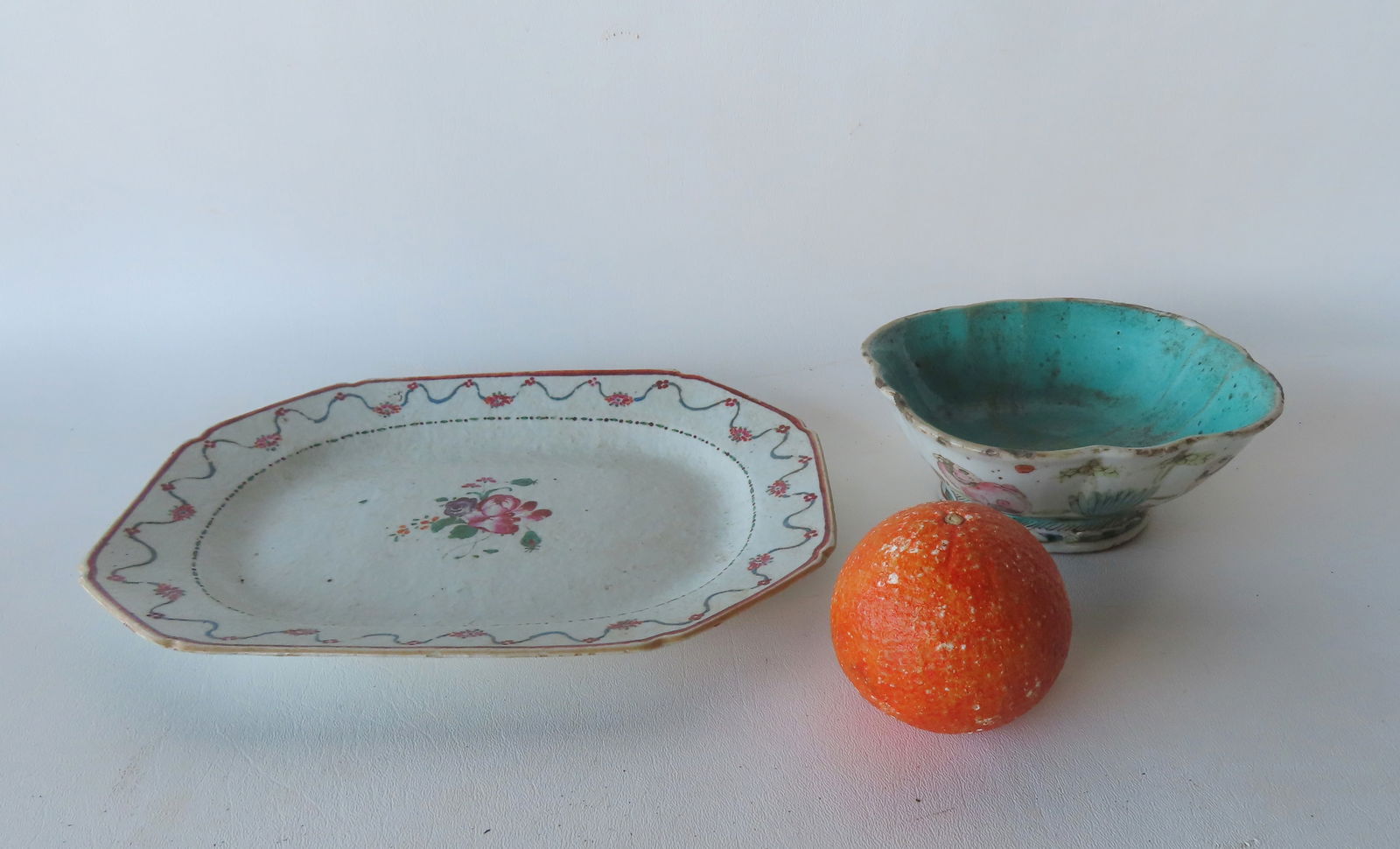 Two pieces of Chinese export porcelains. The first, an octagonal platter decorated with hand painted: Two pieces of Chinese export porcelains. The first, an octagonal platter decorated with hand painted flowers in the center surrounded by a border of flowers on vine, 18th century - very good condition