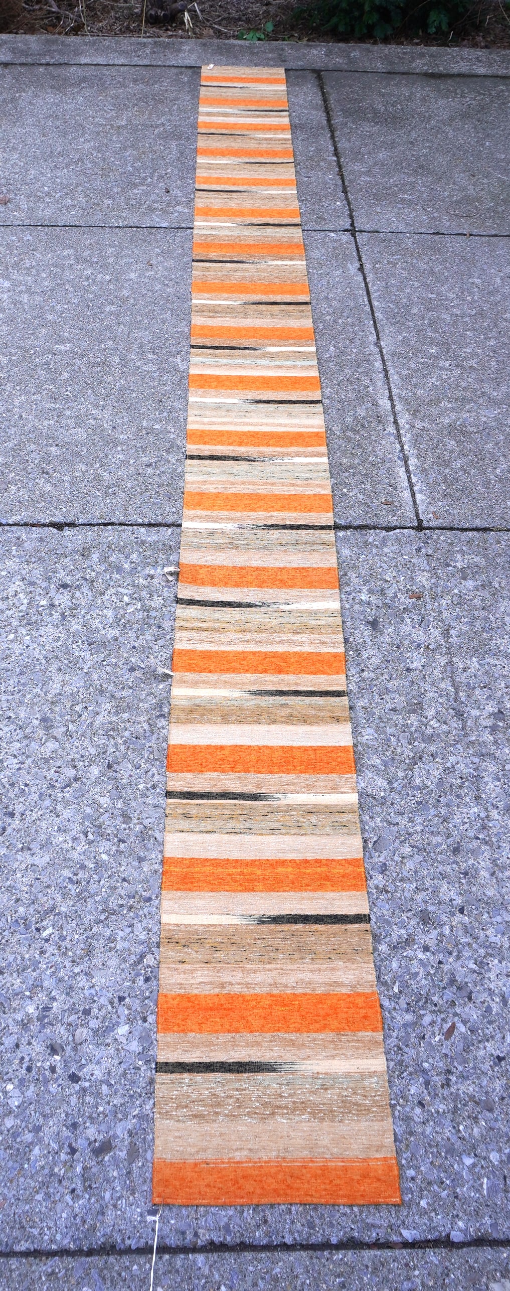 A long colorful woven Japanese Minimalist striped runner, probably late 20th century.: A long colorful woven Japanese Minimalist striped runner with original tags still attached, excellent condition. Probably late 20th century. Measures 11' 10 1/2"L x 11 3/4"W. For use in narrow hallway
