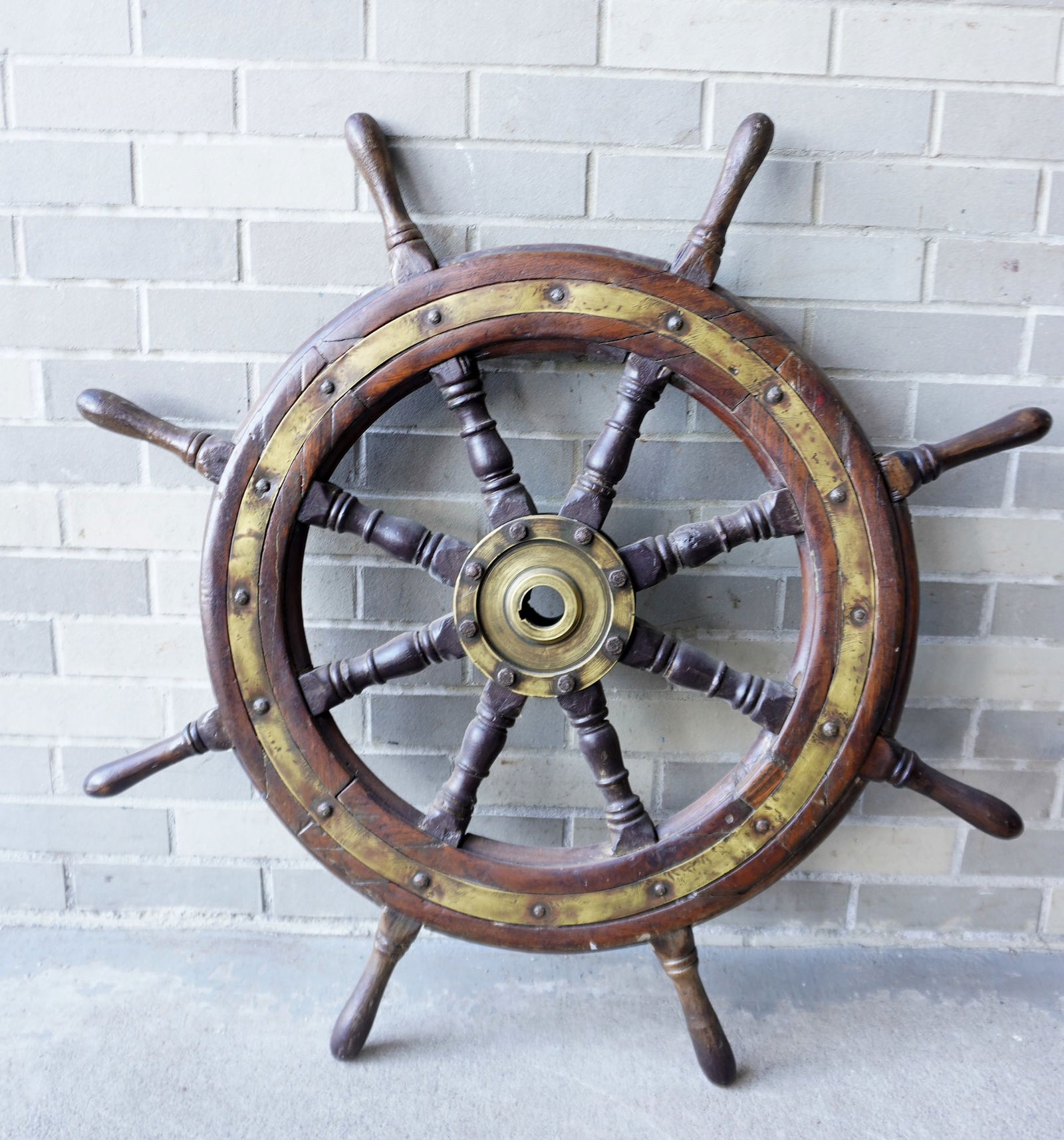 A wood and brass ship's wheel, 19th century - good condition. Measures 34 3/4" diameter. Provenance: (1 of 6)