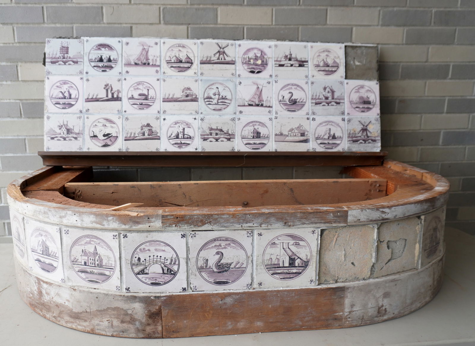 Grouping of 41 purple Dutch Delft tiles, 18th century, all affixed with cement on wooden boards,: Grouping of 41 purple Dutch Delft tiles, 18th century, all affixed with cement on wooden boards, probably part of a fireplace surround, in 2 sections (1 tile is loose from the boards). Note that these