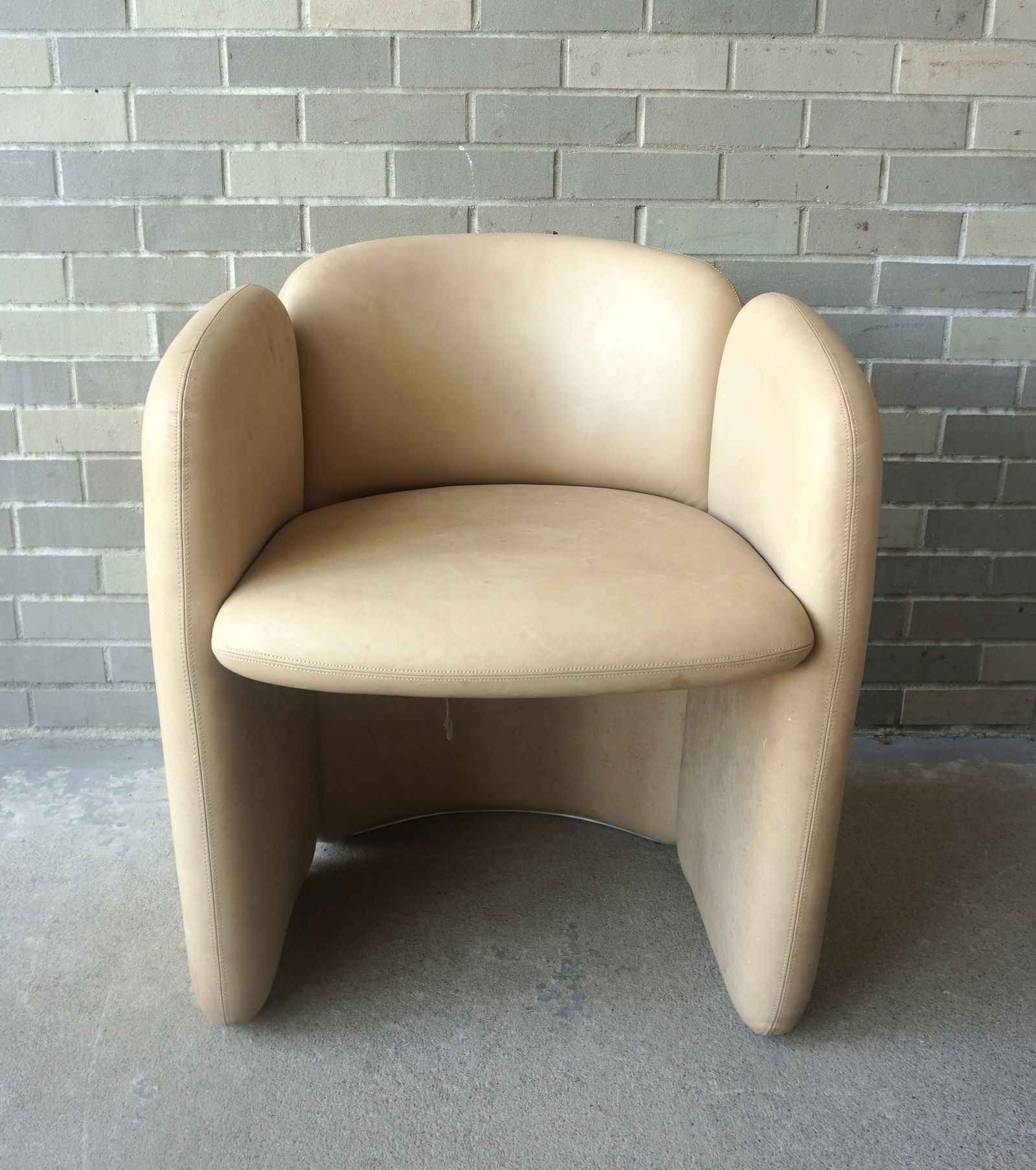 A mid-century modern style leather parlor chair, late 20th to early 21st century, not signed, but: A mid-century modern style leather parlor chair, late 20th to early 21st century, not signed, but similar to Oh-lá-lá chair by Koket. Measures 24"W x 23"D x 29 1/2"H. Some discoloration that may be